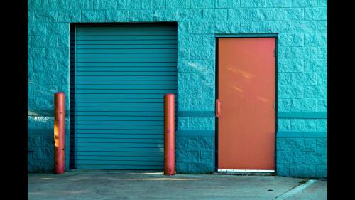 Brown Panel Door Near Roll-up Gate