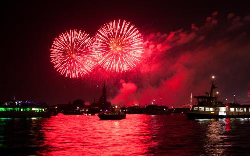 Red neon fireworks over the ocean