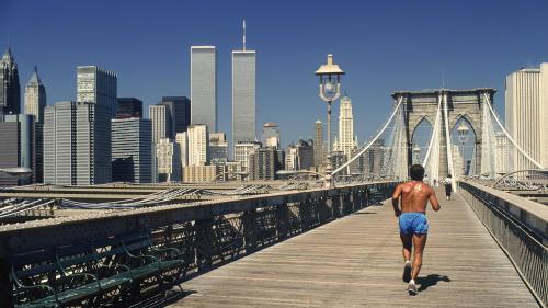 Taking a jog on Brooklyn Bridge with Twin Towers by Dino Fracchia, 1985