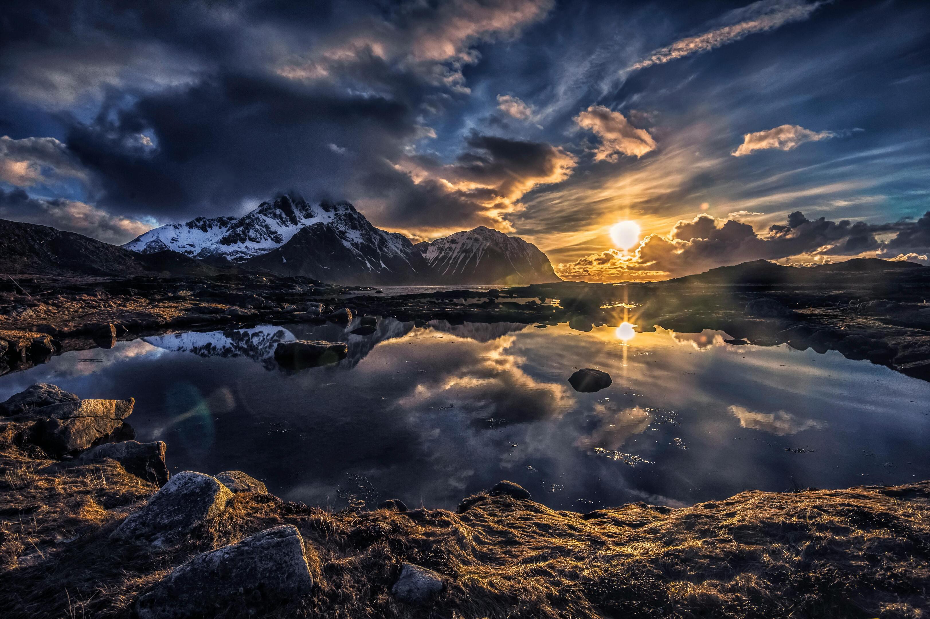 Fire and Ice — Midnight Sun Reflecting over Snow-Capped Lofoten Mountains, Norway