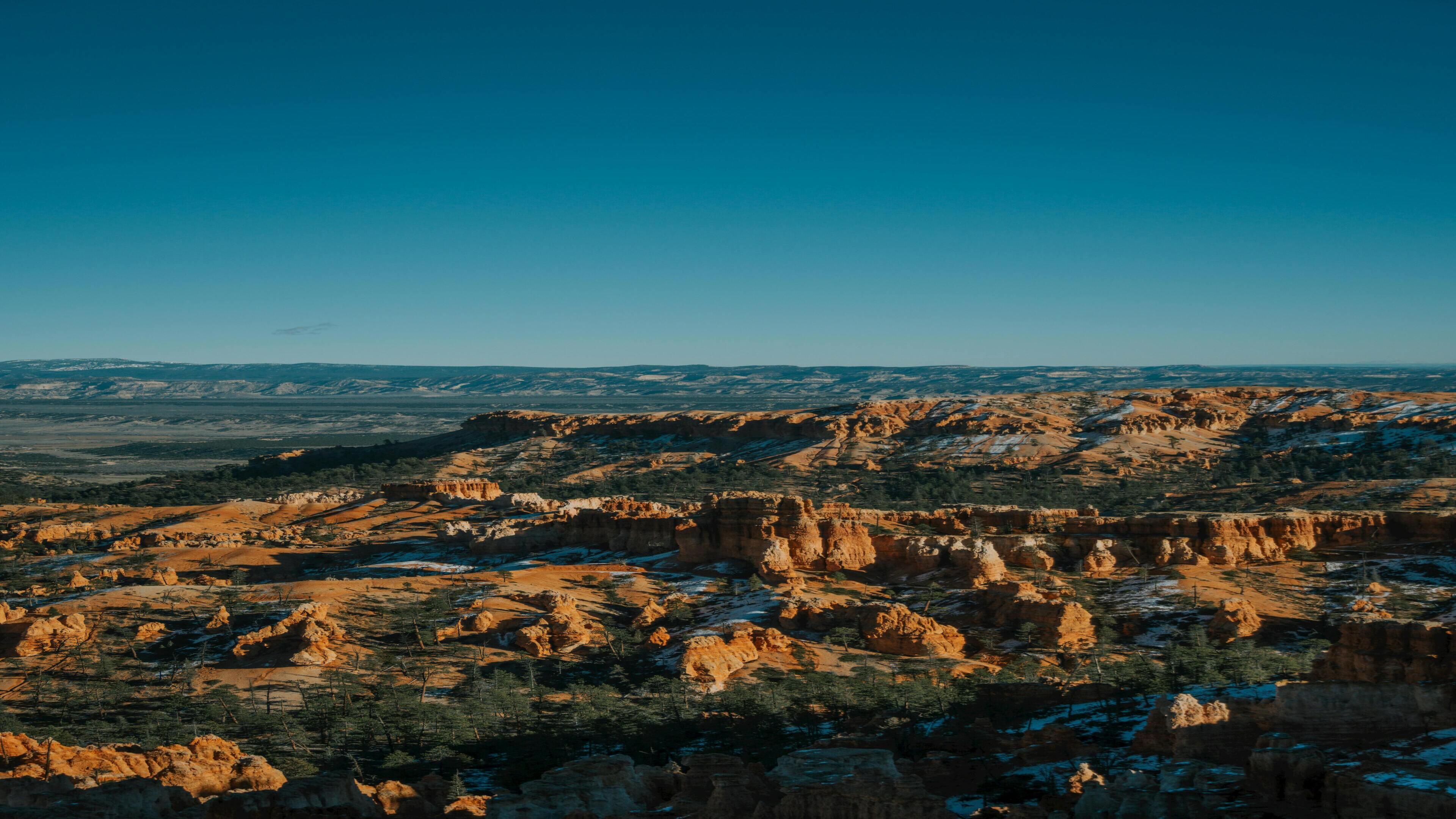 Bryce Canyon's iconic hoodoos dusted with snow under a crystal-clear winter sky — Utah, USA