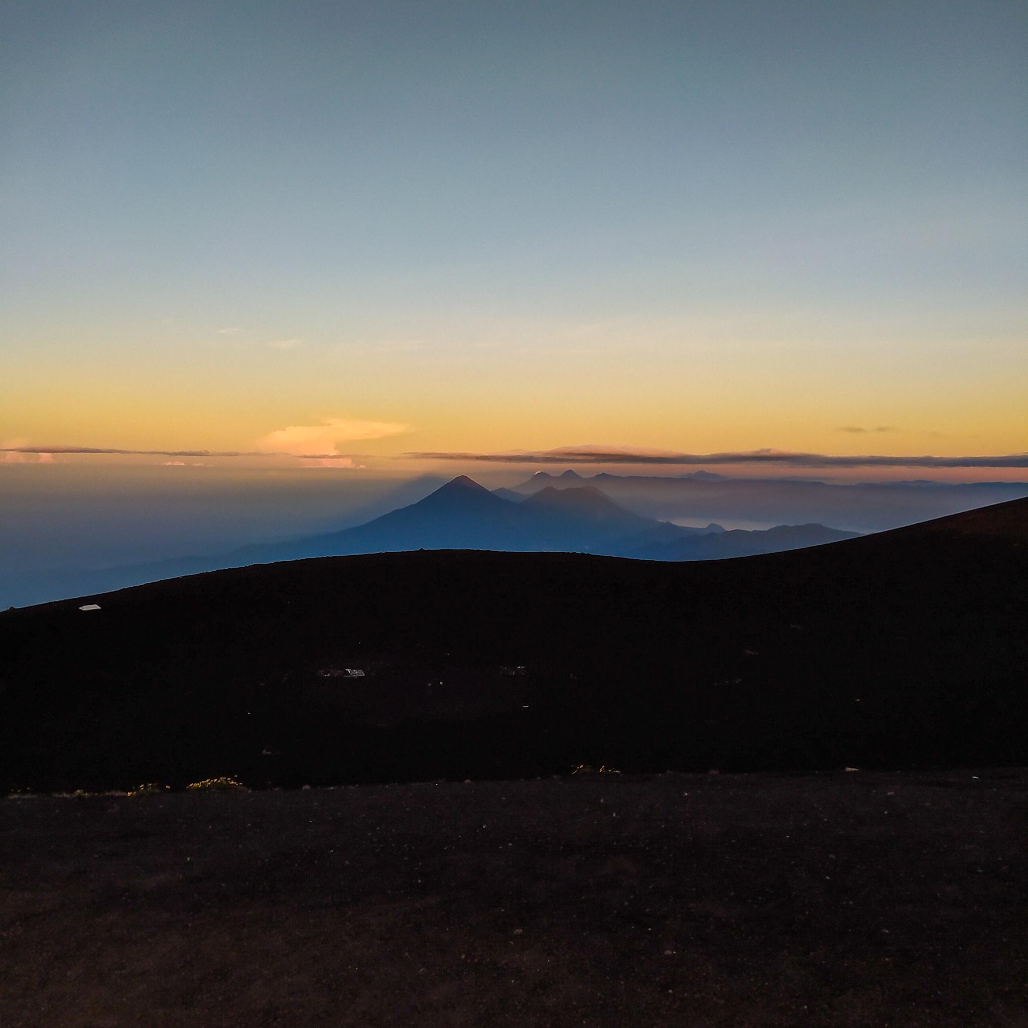 View at the peak of the Acatenango Volcano during the sunrise and the western volcanic chain and Lake Atitlán, Guatemala.