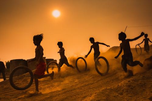 Asian children play with tyre