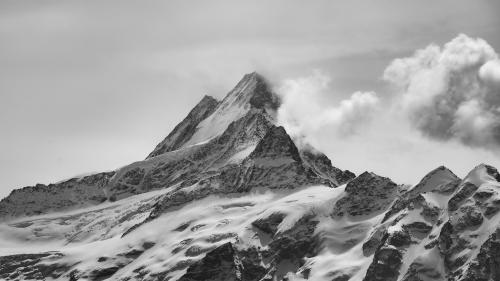 Mighty Schreckhorn rising through the thick clouds in Switzerland