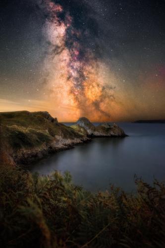 The Milkyway setting over Three Cliffs Bay, South Wales, UK.
