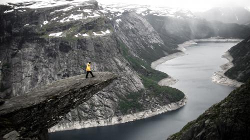 Person Standing on Edge of Cliff