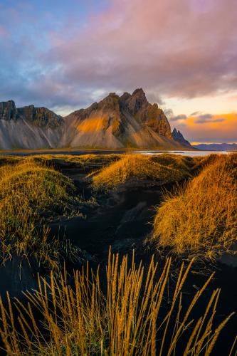 Black sand dunes, jagged peaks, and a crazy sunset. Stokksnes, Iceland  by @explorerhans