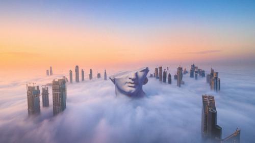 Greek bust above Dubai clouds
