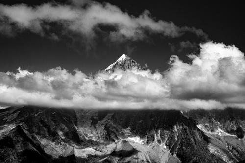 Aiguille Vert poking through the clouds above Chamonix, France.