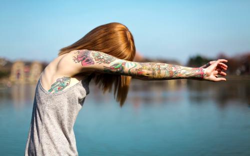 A girl with tattooed arms