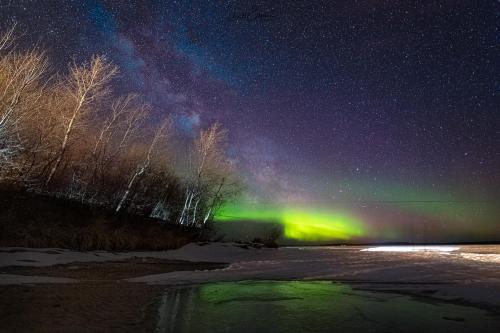 Pinehouse Lake, northern Saskatchewan, Canada. A spring thaw begins with the northern lights.