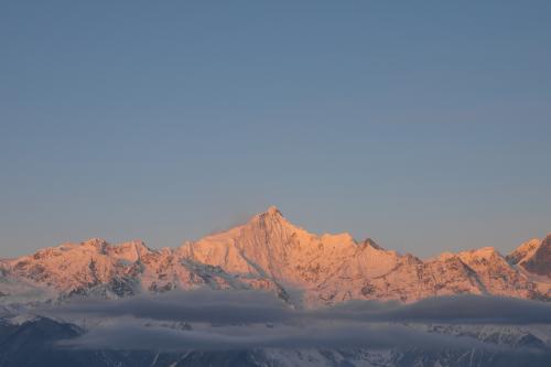 Golden rays of the sun over Meili Snow Mountains, Deqin County, Yunnan Province, China
