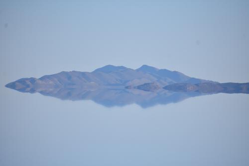 The Salar de Uyuni in Bolivia is a vast salt flat, covered in parts by a few inches of water. The whiteness of the salt under the blueness of the sky creates a mirror-like effect in which the horizon disappears. A truly magical place.