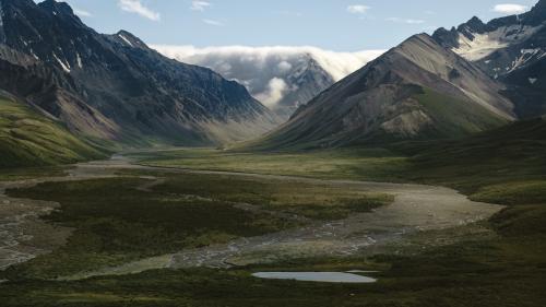 Clouds spilling over the mountains into Polychrome pass, Denali National Park, AK