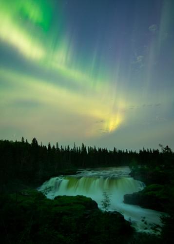 Aurora dancing over Pisew Falls, Manitoba, Canada