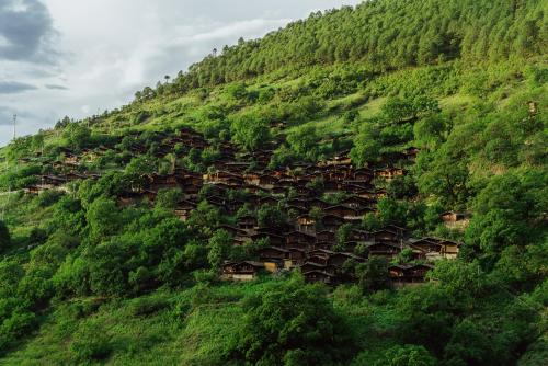 TongLe , A traditional Lisu village in China , build on the mountainside . 2021. China