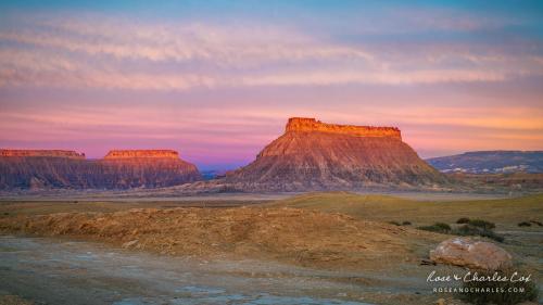 Sunrise View of Factory Butte in Southern Utah, a 1500 foot high isolated red rock peak in the middle of the badlands