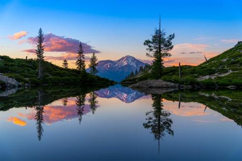 Sometimes real life really does look like a painting. Mt. Shasta and it's reflection in a small mountain lake in Northern California.