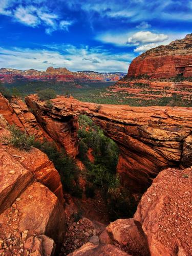 Devils Bridge overlooking the red, green, and blue colors that are Sedona, AZ