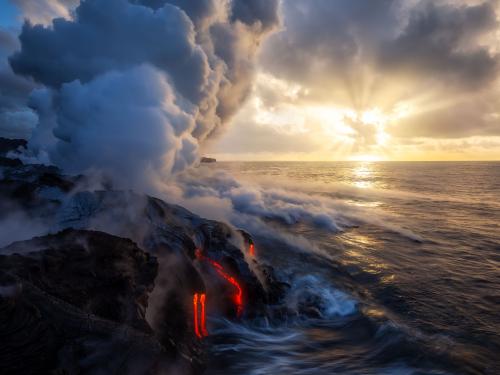 Watching an island grow at sunrise. Hawaii.