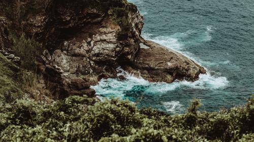 waves of sea splashing on rocky coast