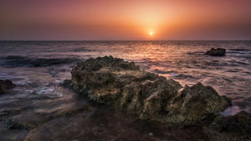 Brown Rock Formation on Sea During Golden Hour