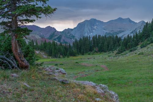 Distant showers and the sound of marmots chirps echoing off the mountains. Rocky Mountains, USA
