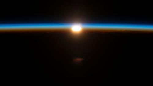 "An orbital sunrise begins to illuminate Earth's atmosphere in this photograph" taken on July 2, 2023 "from the International Space Station as it orbited 270 miles above the south Pacific Ocean about 2,200 miles west of New Zealand."