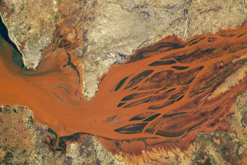 The "reddish-brown waters of the Betsiboka River Delta in Madagascar" photographed on September 30, 2023 from the International Space Station. The "color is caused by the transport of iron-rich sediment."