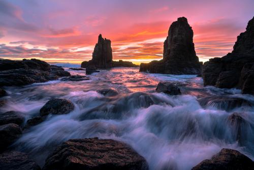 "Enchantment" 2022. South Coast, NSW, Australia. A beautifully large burst of light graces itself upon the ocean amongst the sea stacks.