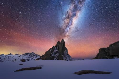 The Milky Way galactic core and red airglow rising over the impressively tall Aries Tor in Kosciuszko NP, NSW Australia.