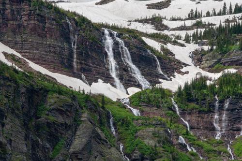 Waterfall streams cascading down into Grinnell Lake in Glacier National Park.