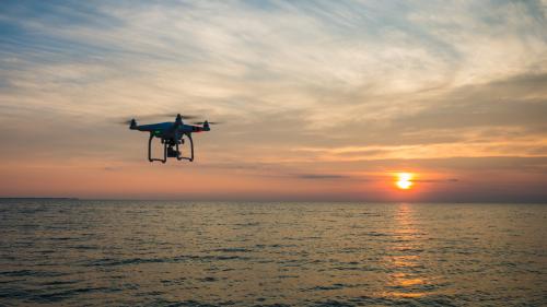 drone flying towards sun