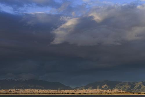 Clouds building over Great Sand Dunes as the sun sets