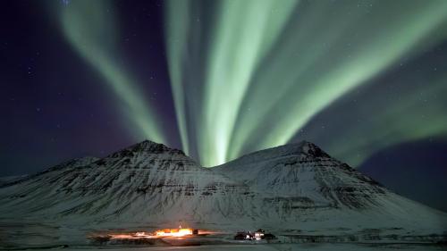 Northern Lights "eruption" over a volcano in Iceland