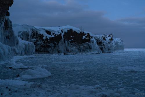 The grim beauty of a frozen Lake Superior shore at dusk - Presque Isle Park, Marquette, Michigan