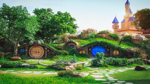 Fantasy meadow with colorful houses and palace