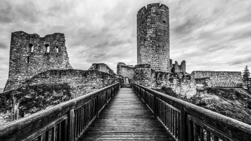 Wooden bridge to fortress ruins in monochrome