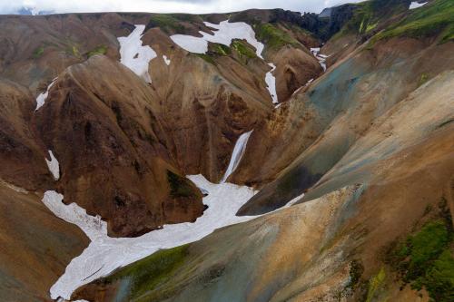 Unnamed veiled waterfall into snow in Iceland near but not in Landmannalauger.