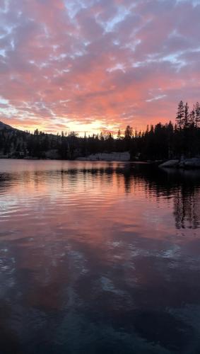 Magnificent sunset with blue marbled glow across Cathedral Lake, Yosemite.