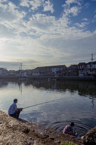 Fishing and laundry in the same river at the same time. 2013 YinJiang China