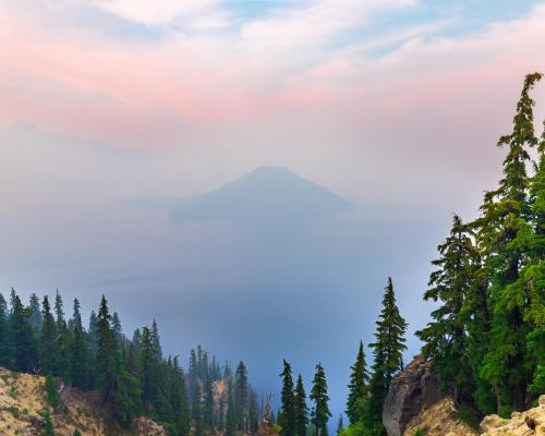 Lake filled with smoke and sunset light above the smoke line. Crater Lake, Oregon