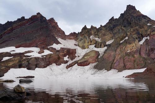 No Name Lake reflecting volcanic rock and snow, Deschutes National Forest, Oregon