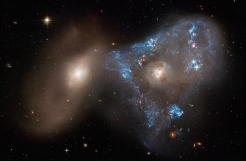Interacting Galaxies Arp 143. After they passed through each other the gas rich galaxy on the right started to form loads of stars. Their gravities still visibly affect each other.