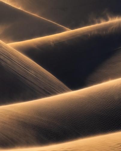Layers of wind blown sand dunes on an afternoon in Namibia.
