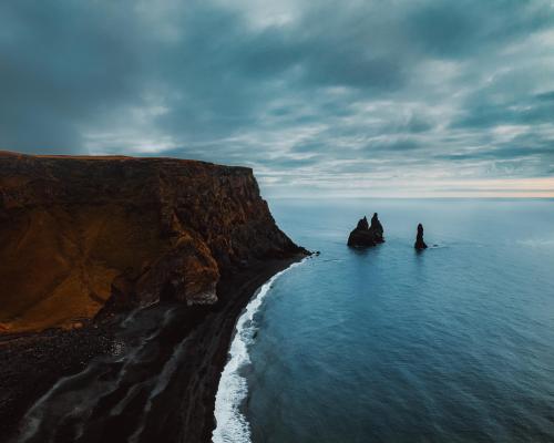 Black Sand Beach, Iceland where the lava rocks meet the ocean