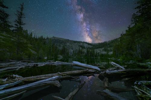 The beautiful night sky and it's reflection near the outlet creek of a gorgeous mountain lake in Northern California.