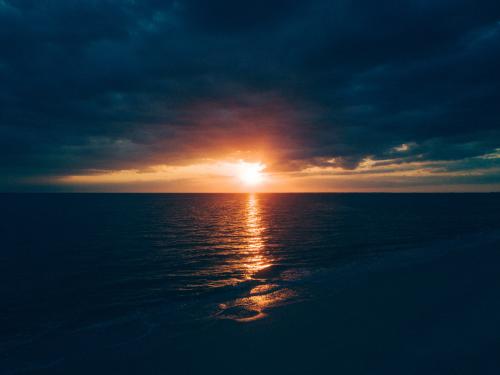 Body of water under nimbus clouds