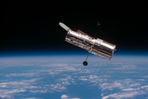 February 1997: "The Hubble Space Telescope  begins its separation from the Space Shuttle Discovery following its release. This view was taken with an Electronic Still Camera ."