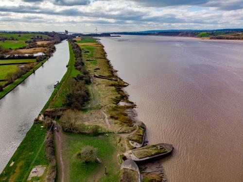 River Severn and Sharpness Canal at Purton, UK. Note the ship graveyard put there to stop the river eroding the bank between it and the canal. Size: 3989 x 2992